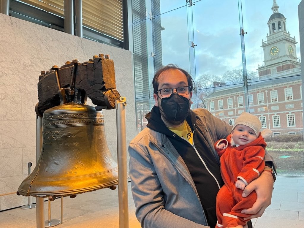 The author and his baby in front of the Liberty Bell, with Independence Hall behind them.