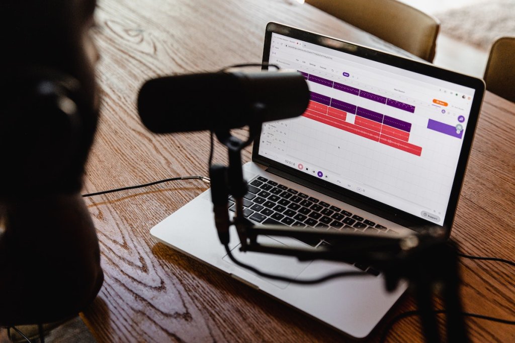 A podcasting setup with a microphone and a laptop