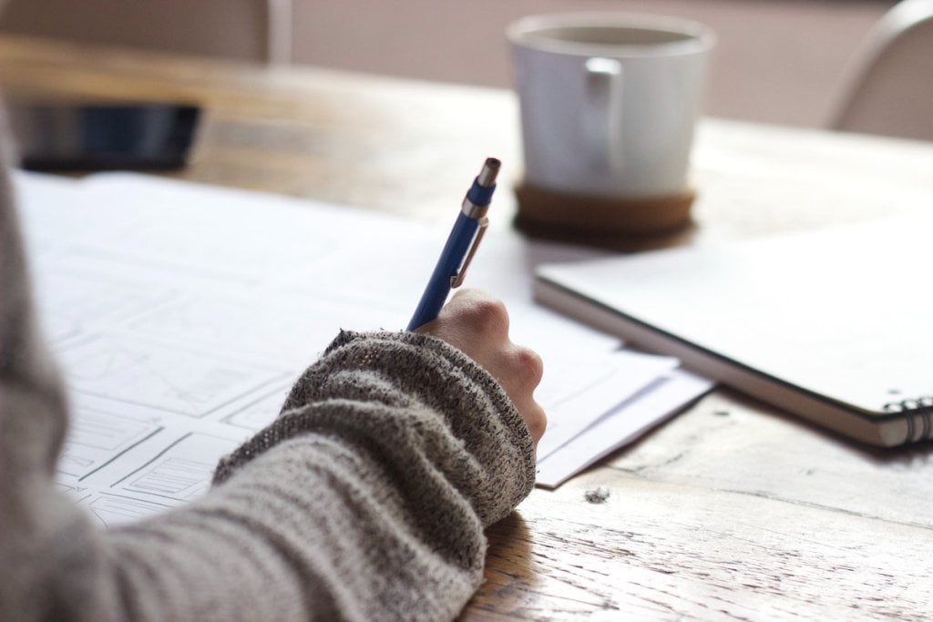 A writer at their desk, planning