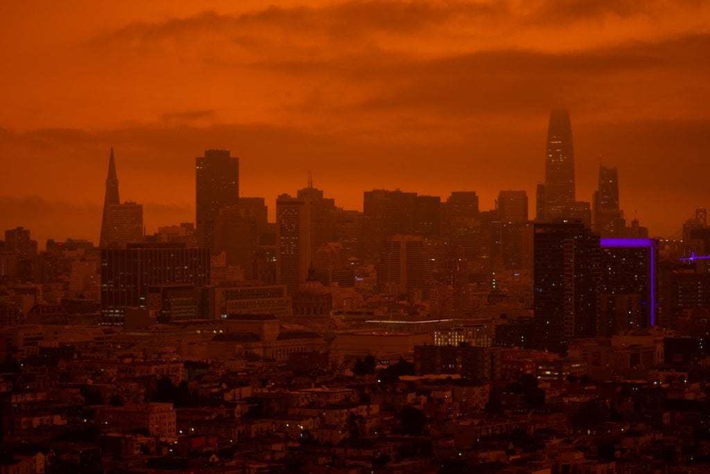The San Francisco skyline, bathed in murky red light.