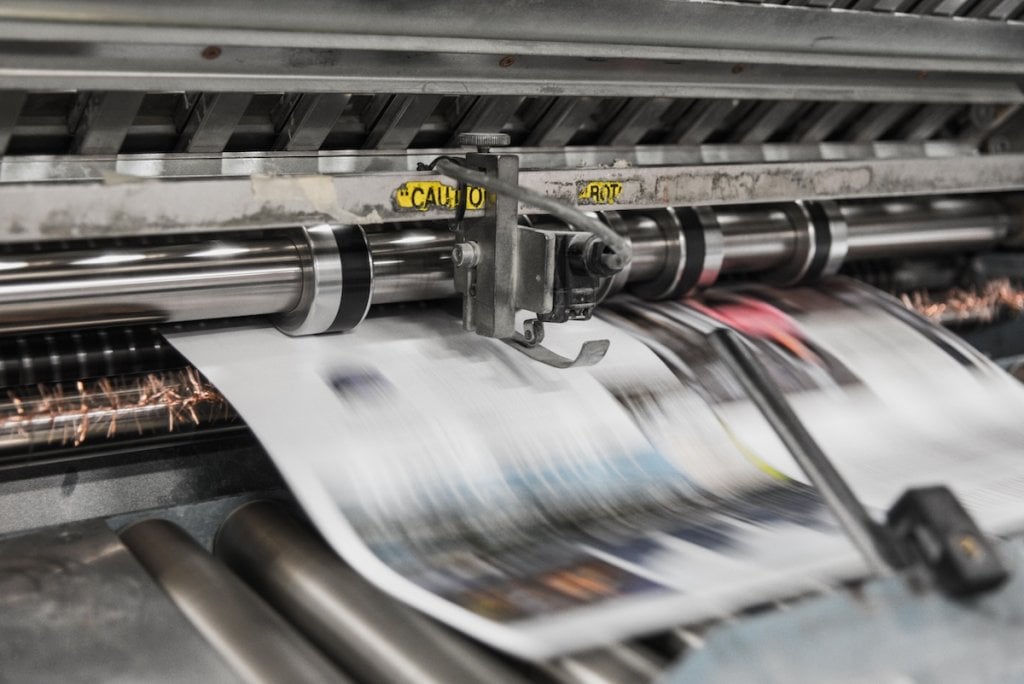 A newspaper coming off the press